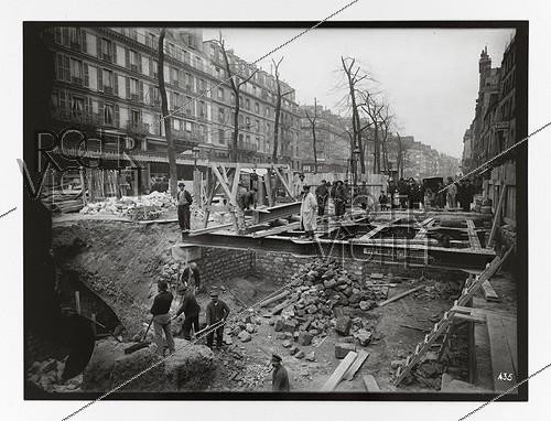 Roger-Viollet | 220741 | Construction du chemin de fer métropolitain municipal de Paris : ligne 1, 4ème lot (435). Accès de la station Saint-Paul. Mise en place de la charpente métallique. Paris (4e arr.), 16 mars 1900. Photographie de Charles Maindron (1861-1940). Paris, bibliothèque de l'Hôtel de Ville. | &copy; Charles Maindron / BHdV / Roger-Viollet