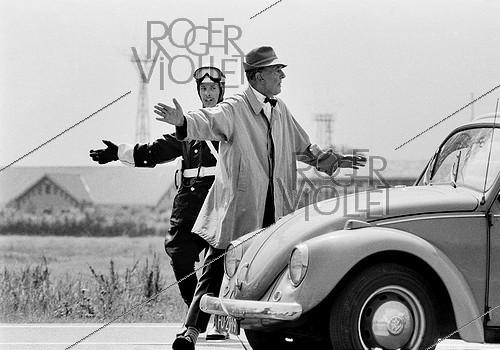 Roger-Viollet | 1375914 | Jacques Tati (1907-1982), French film-maker, actor and cult scriptwriter of French cinéma. Shooting of the film  Trafic  released in 1971. Amsterdam (Netherlands), 9 July 1970. Photograh by André Perlstein (born in 1942). | &copy; André Perlstein / Roger-Viollet