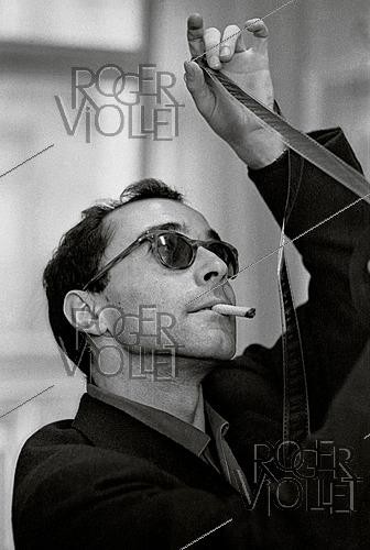 Roger-Viollet | 1644154 | Jean-Luc Godard (1930–2022), French-born Swiss filmmaker. Paris, 1960s. Photograph by Philippe R. Doumic (1927–2013). | &copy; Philippe R. Doumic / Roger-Viollet