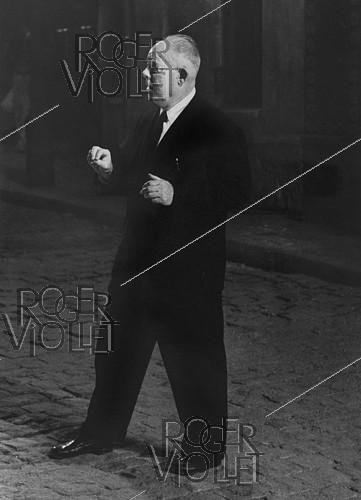 Roger-Viollet | 1021661 | Jean Renoir (1894-1979), French director, on the shooting of  French Cancan  in 1954. Photograph by Jean Marquis (1926-2019). Bibliothèque historique de la Ville de Paris. | &copy; Jean Marquis / BHVP / Roger-Viollet
