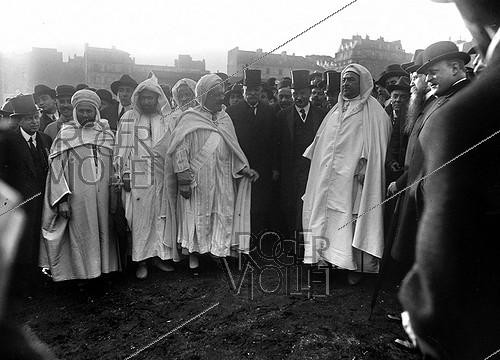 Roger-Viollet | 320016 | Laying of the cornerstone for the Paris Mosque. In the center, from left to right: Si Kaddour Ben Ghabrit, Colrat, and Cair, representatives of the French government, and the Marabout. Paris (5th arrondissement), 1922. | &copy; Albert Harlingue / Roger-Viollet