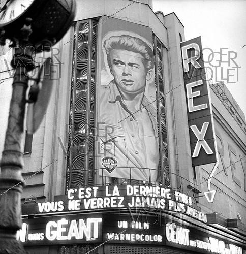Roger-Viollet | 409245 | Portrait of James Dean (1931-1955), American actor, on a poster of his last film  Giant  by George Stevens. Paris, Rex movie theatre, 1956. | &copy; Roger-Viollet / Roger-Viollet