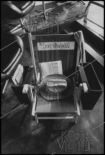 Roger-Viollet | 1375946 | Seat of Jean-Pierre Melville (1917-1973), French film director and scriptwriter. Shooting of his film  Le Cercle Rouge  (The Red Circle). Studios in Boulogne Billancourt (France), 13 February 1970. Photograph by André Perlstein (born in 1942). | &copy; André Perlstein / Roger-Viollet