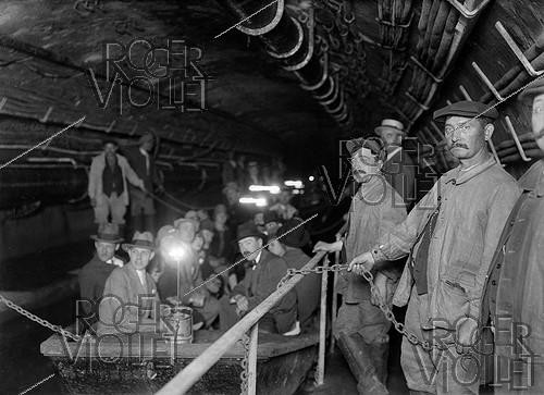 Roger-Viollet | 193946 | Visitors of Paris sewers in a small boat, 1920's. | &copy; Maurice-Louis Branger / Roger-Viollet