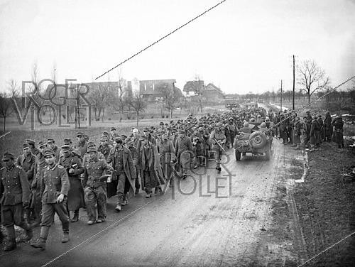 Roger-Viollet | 1421852 | World War II. Column of German prisoners of war walking near Rouffach (France), on February 9, 1945. Photograph fom the collections of the French newspaper  France-Soir . Bibliothèque historique de la Ville de Paris. | &copy; Fonds France-Soir / BHVP / Roger-Viollet