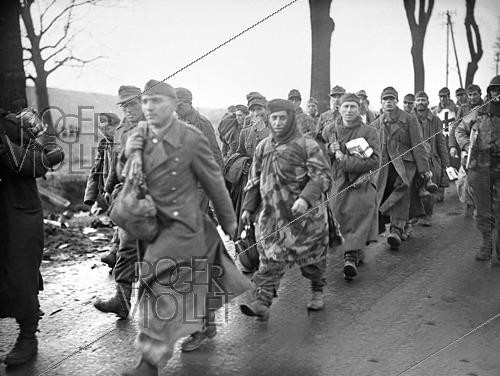Roger-Viollet | 1421853 | World War II. Column of German prisoners of war walking near Rouffach (France), on February 9, 1945. Photograph fom the collections of the French newspaper  France-Soir . Bibliothèque historique de la Ville de Paris. | &copy; Fonds France-Soir / BHVP / Roger-Viollet