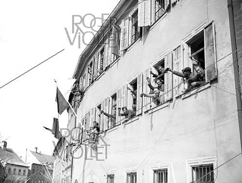 Roger-Viollet | 1421820 | World War II. French flag flying over the Franco-Belgian military camp. Würzburg (Germany), on April 13, 1945. Photograph from the collections of the French newspaper  France-Soir . Bibliothèque historique de la Ville de Paris. | &copy; Fonds France-Soir / BHVP / Roger-Viollet