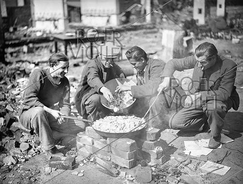 Roger-Viollet | 1421821 | World War II. Prison workers preparing their meal in a Franco-Belgian military camp. Würzburg (Germany), on April 13, 1945. Photograph from the collections of the French newspaper  France-Soir . Bibliothèque historique de la Ville de Paris. | &copy; Fonds France-Soir / BHVP / Roger-Viollet