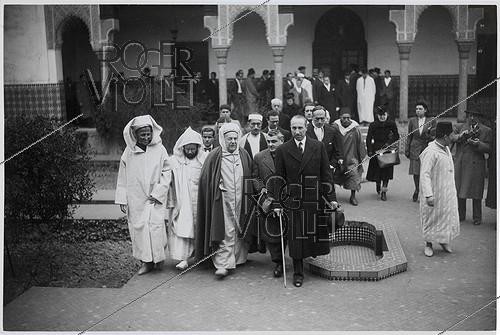 Roger-Viollet | 130132 | World War II. Propaganda photograph: Max Bonnafous (1900–1975) and René Bouffet (1896–1945), French politicians meet Si Kaddour Benghabrit (1868–1954), an Algerian theologian and senior official, at the Grand Mosque of Paris on the day of Mouloud. Paris (5th arrondissement). Photograph from the newspaper  Le Petit Parisien.  Paris, Carnavalet Museum. | &copy; Musée Carnavalet / Roger-Viollet